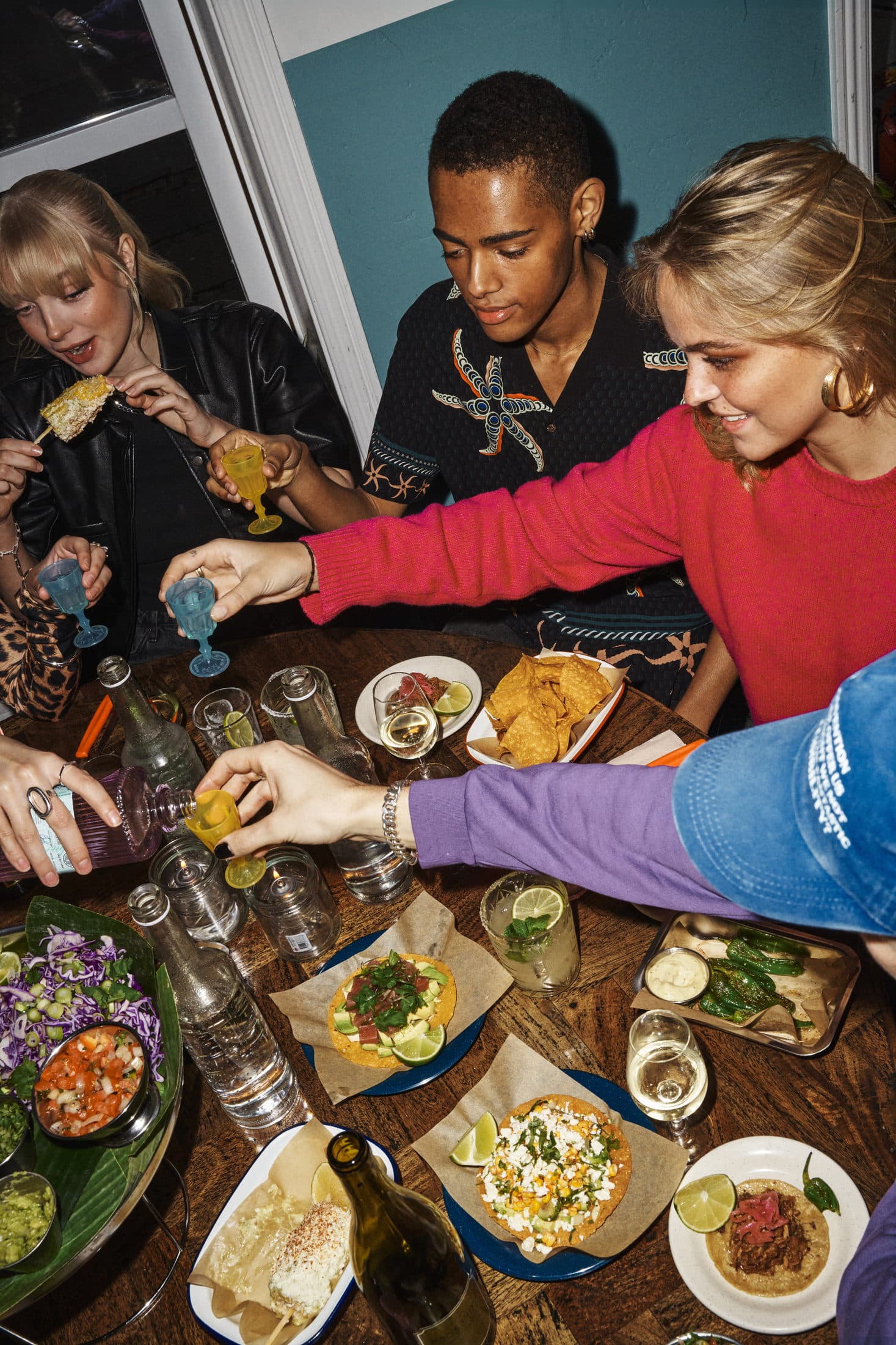 A group sharing tacos and drinks